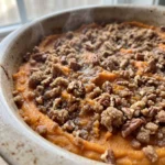 Sweet potato casserole topped with pecans, brown sugar, and toasted marshmallows.